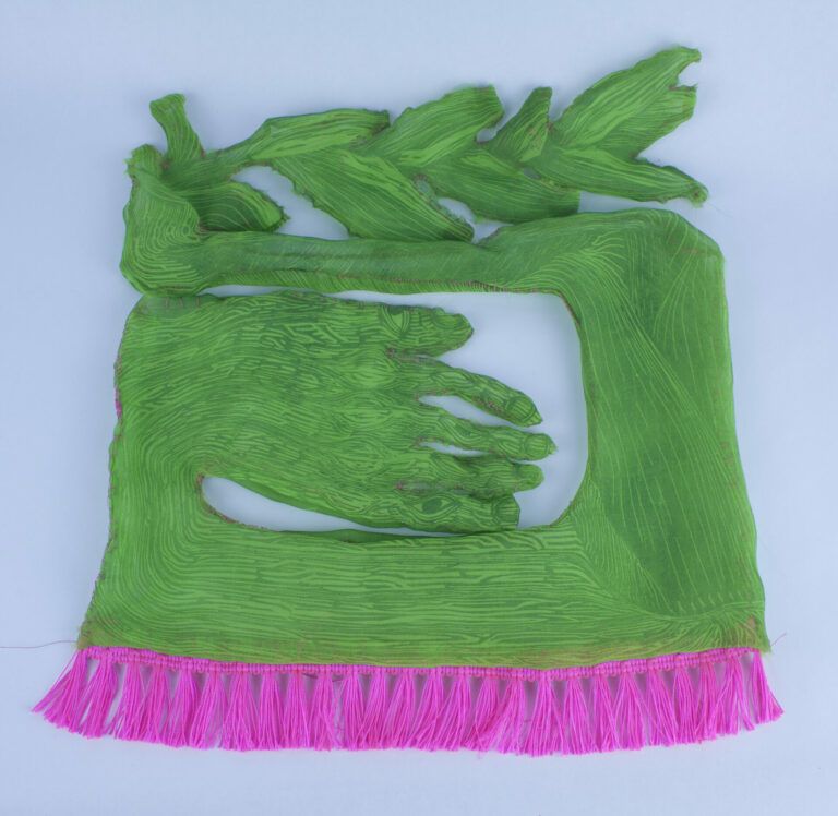 Relief print on chiffon. A plant shape at the top turns into a green hand. There are pink tassels at the bottom.