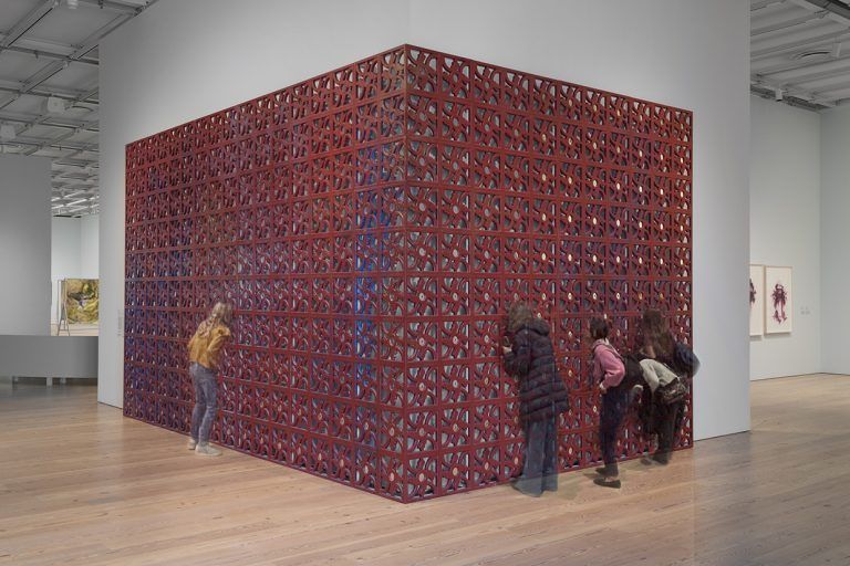 Large red gates common in Puerto Rican culture intersect to create a corner.