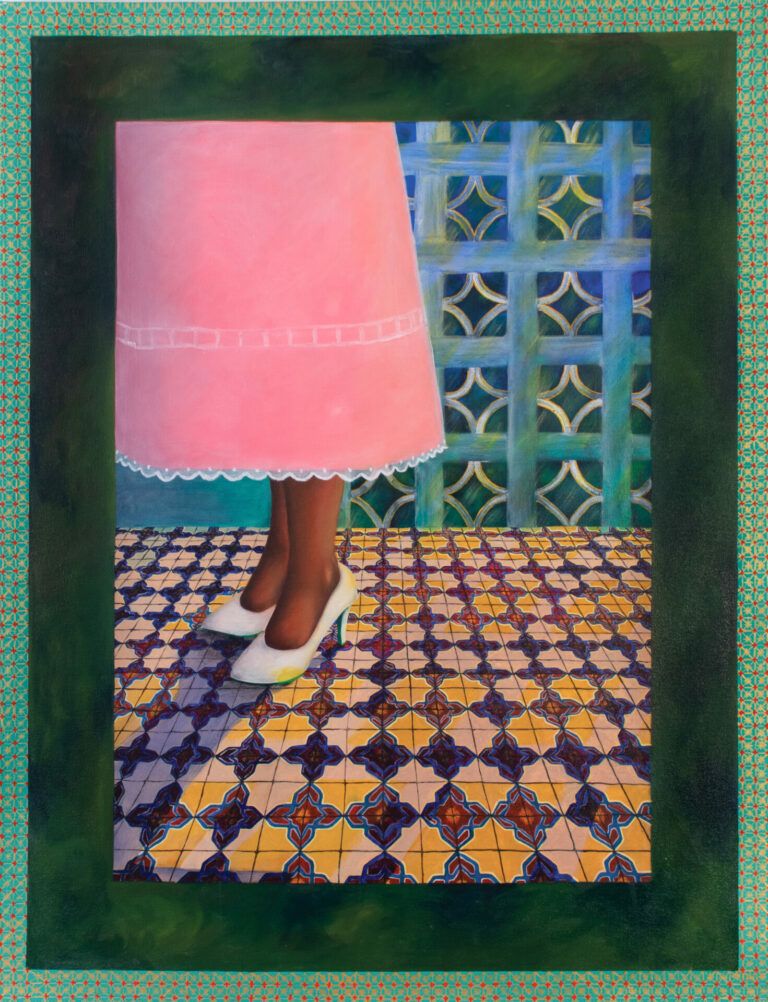 Woman in a pink dress standing on tile in front of breeze blocks.