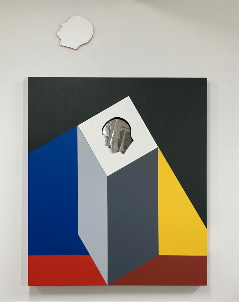 A painting of an illusory rectangular pillar with a facial profile shape painted to look like it is cut out of the pillar at the top. The grey pillar is surrounded by blue and yellow triangles, a black polygon, and two red trapezoids.