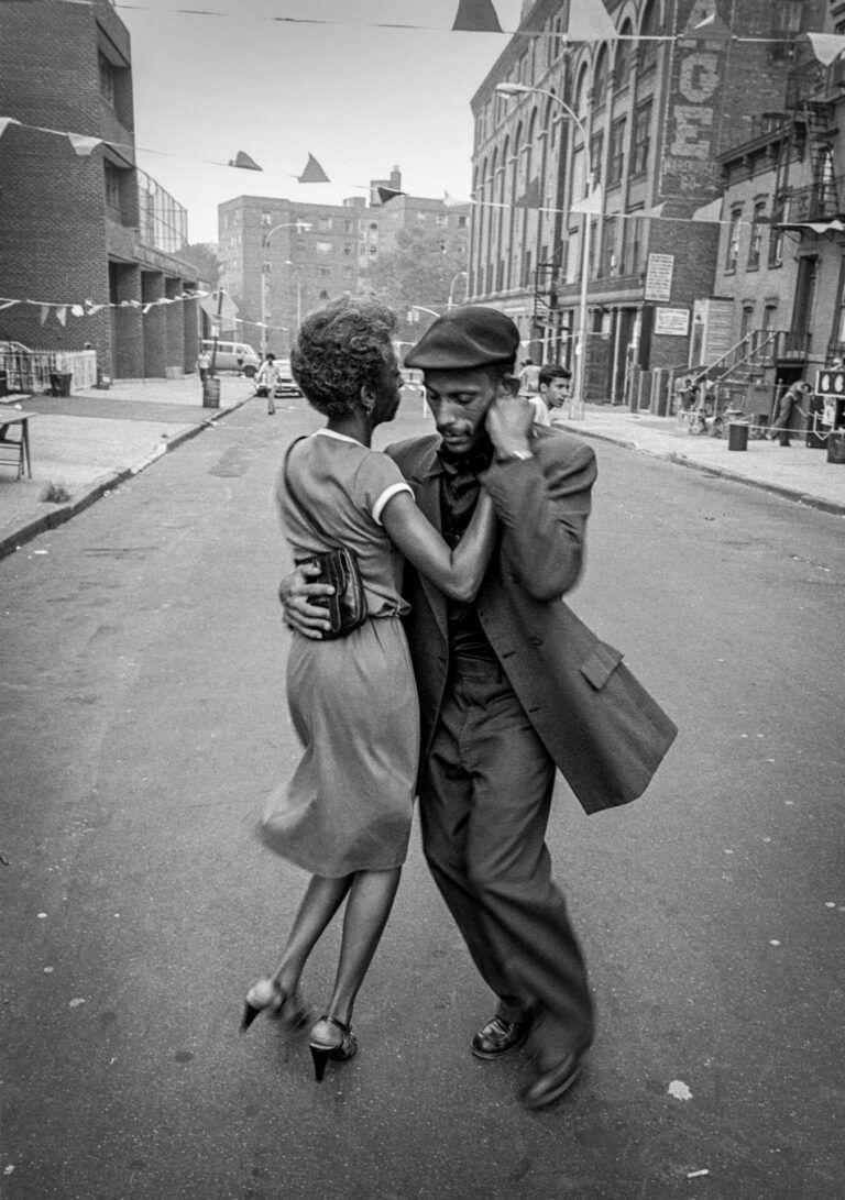 "Here we have a couple, dressed to the nines, dancing in the streets when the outside world saw the South Bronx as irredeemable. Yet there, embracing and dancing to the soundtrack of an unseen band, they remind us how our roots, our culture, nourish our souls." - David Gonzalez