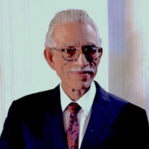 A photo of artist Jorge Luis Rodríguez. He wears glasses and smiles toward the camera.