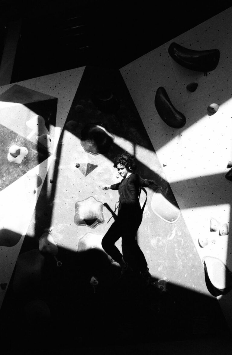Black and white photograph of actress and stunt performer Emely Cartagena training at her local climbing gym in Brooklyn, New York.