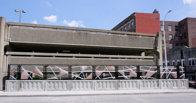 Geometric shapes cut to make a fence-type sculpture. The shapes mimic percussion instruments, meant to play by hand.