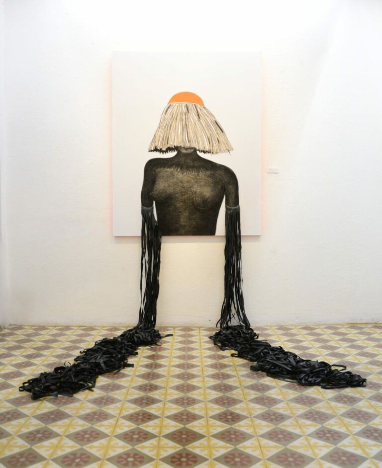 Drawing of a woman wearing a straw hat that covers her face. She is nude and her arms turn into strands of tires that fall out of the canvas onto the floor.
