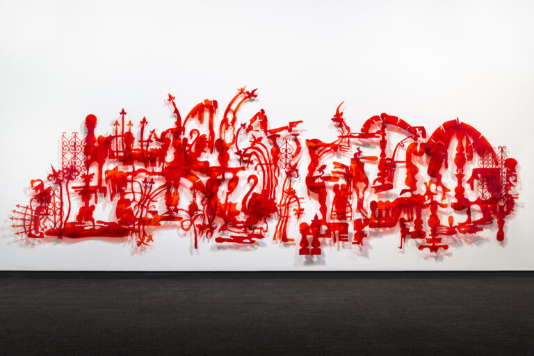 Red plastic in the various shapes of fences arranged in the general shape of Puerto Rico.