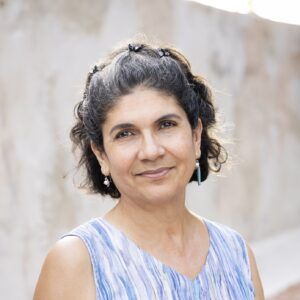 A close up photo of artist Amanda Carmona Bosch. She smiles at the camera.