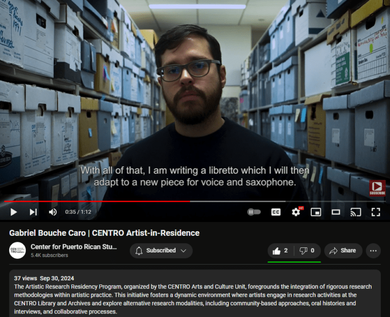 Gabriel Bouche Caro stands between rows of boxes in the archives at the Silberman School of Social Work. "With all of that, I am writing a libretto which I will then adapt to a new piece for voice and saxophone."