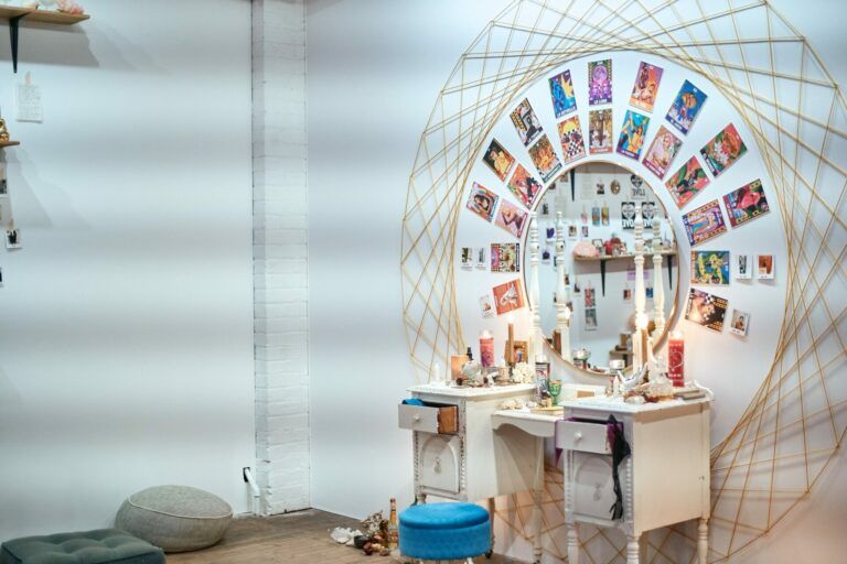 Altar with rows of concentric tarot cards, a mirror, and string art at Public Functionary.