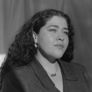 Black and white photo of Alexis Marie Montoya dressed professionally.