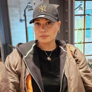 Jani Maria wears a Yankees cap and a jacket indoors.