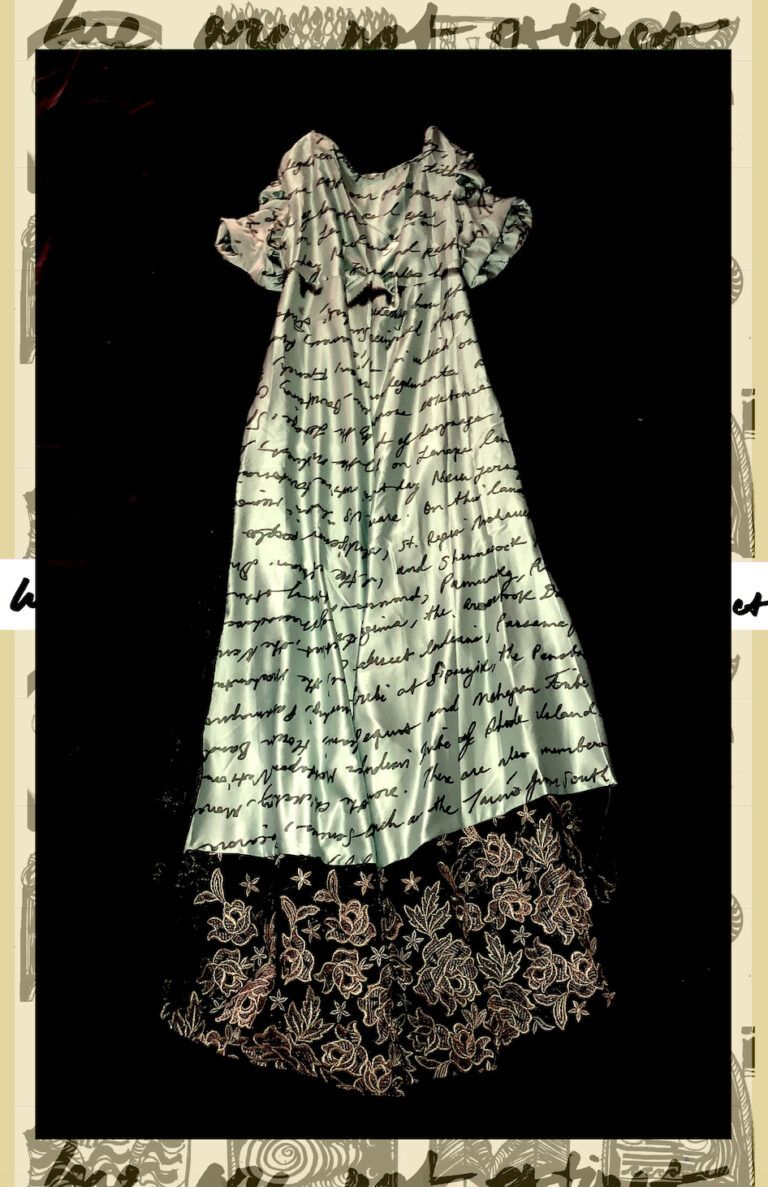 A white dress patterned with text and lace.