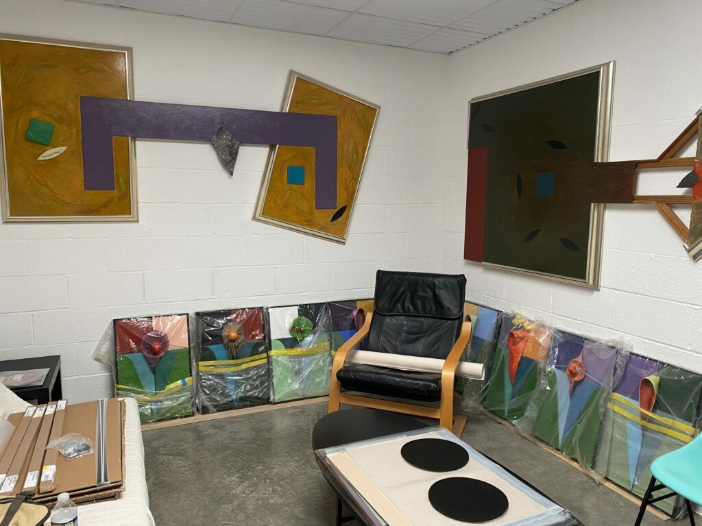 A view of Lope Max Díaz' studio with a chair and wrapped paintings.
