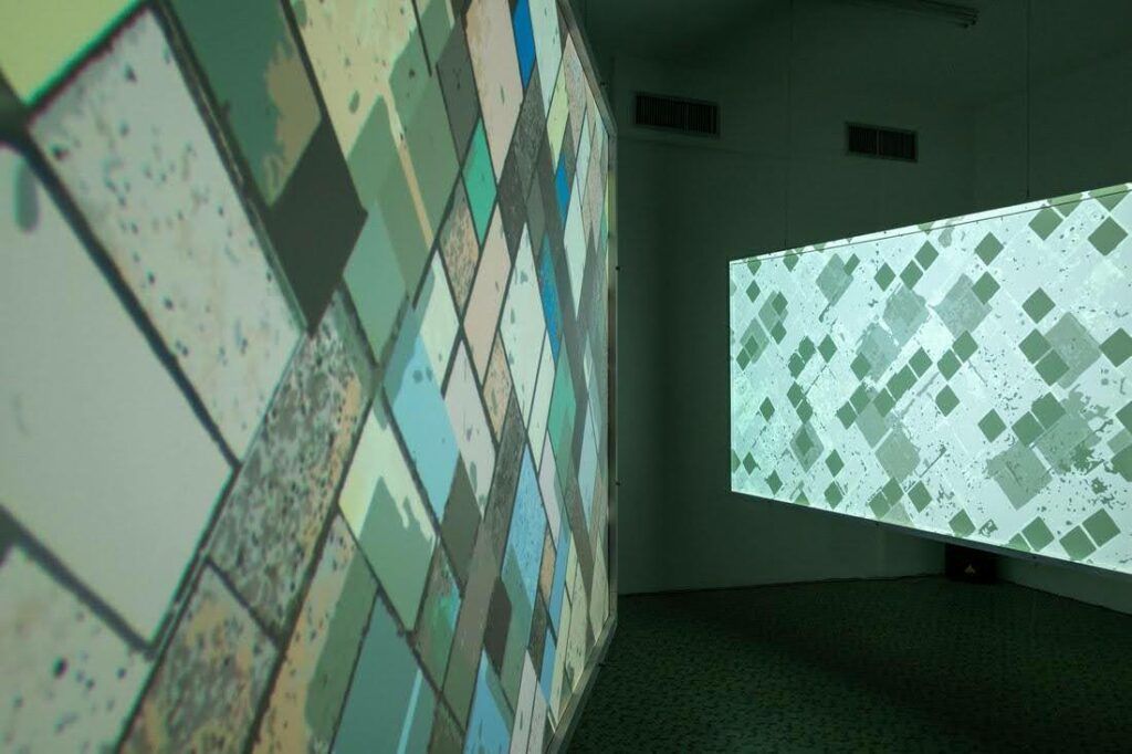 Installation of works that look like the square and blocky aerial view of farmland from a plane.