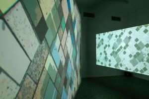 Installation of works that look like the square and blocky aerial view of farmland from a plane.