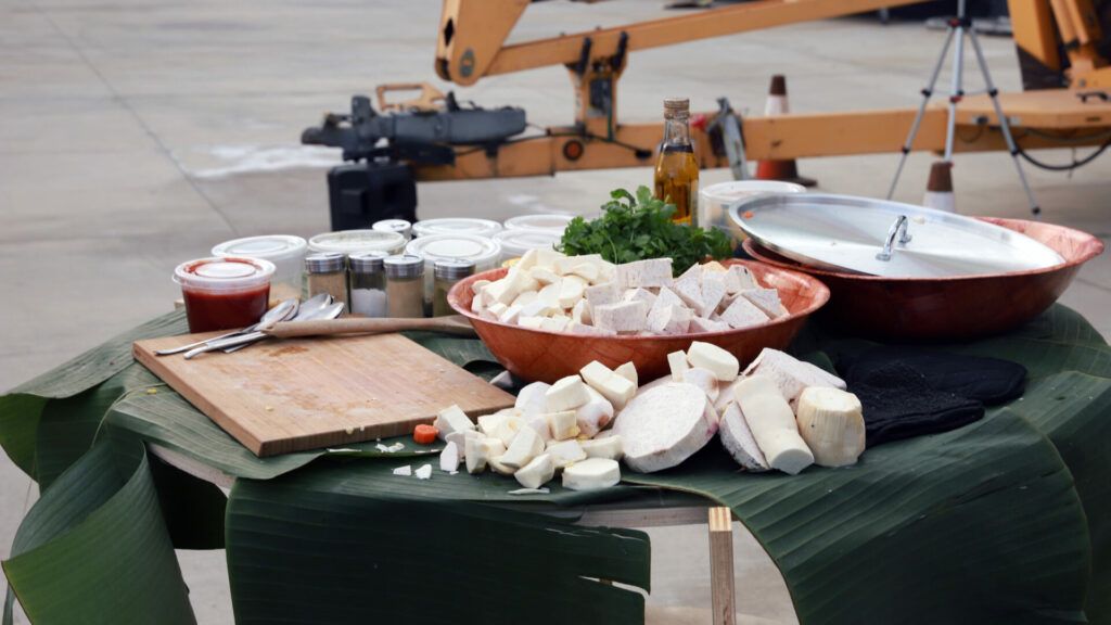 Raw cooking materials used for the performance wait on a green table.