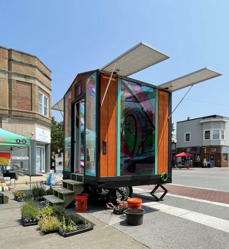 A small bright colored isolated room in the middle of a city street.