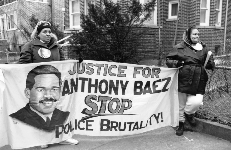 Protesters against police brutality holding a sign that reads "Justice for Anthony Baez"